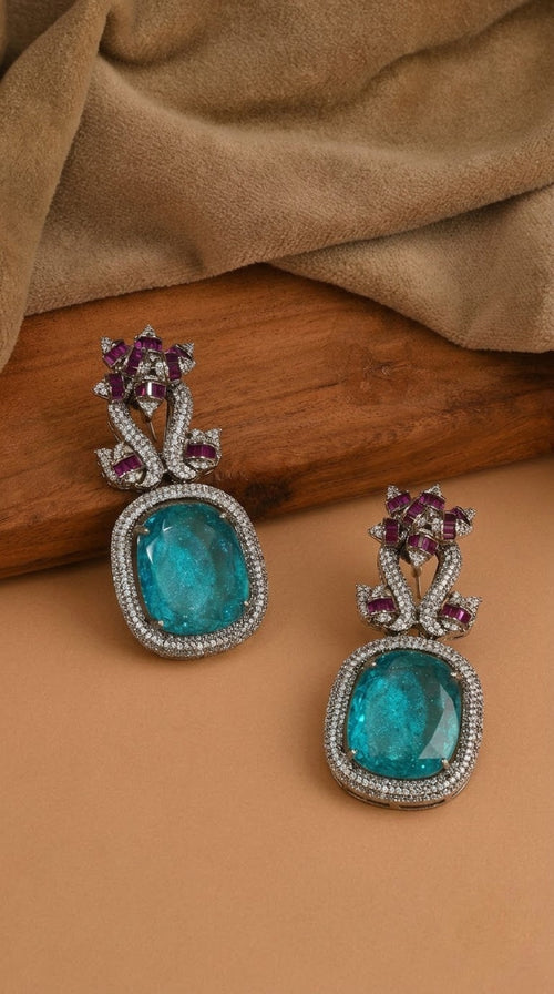 Drop earrings with large aqua-blue stone and fuchsia flower top