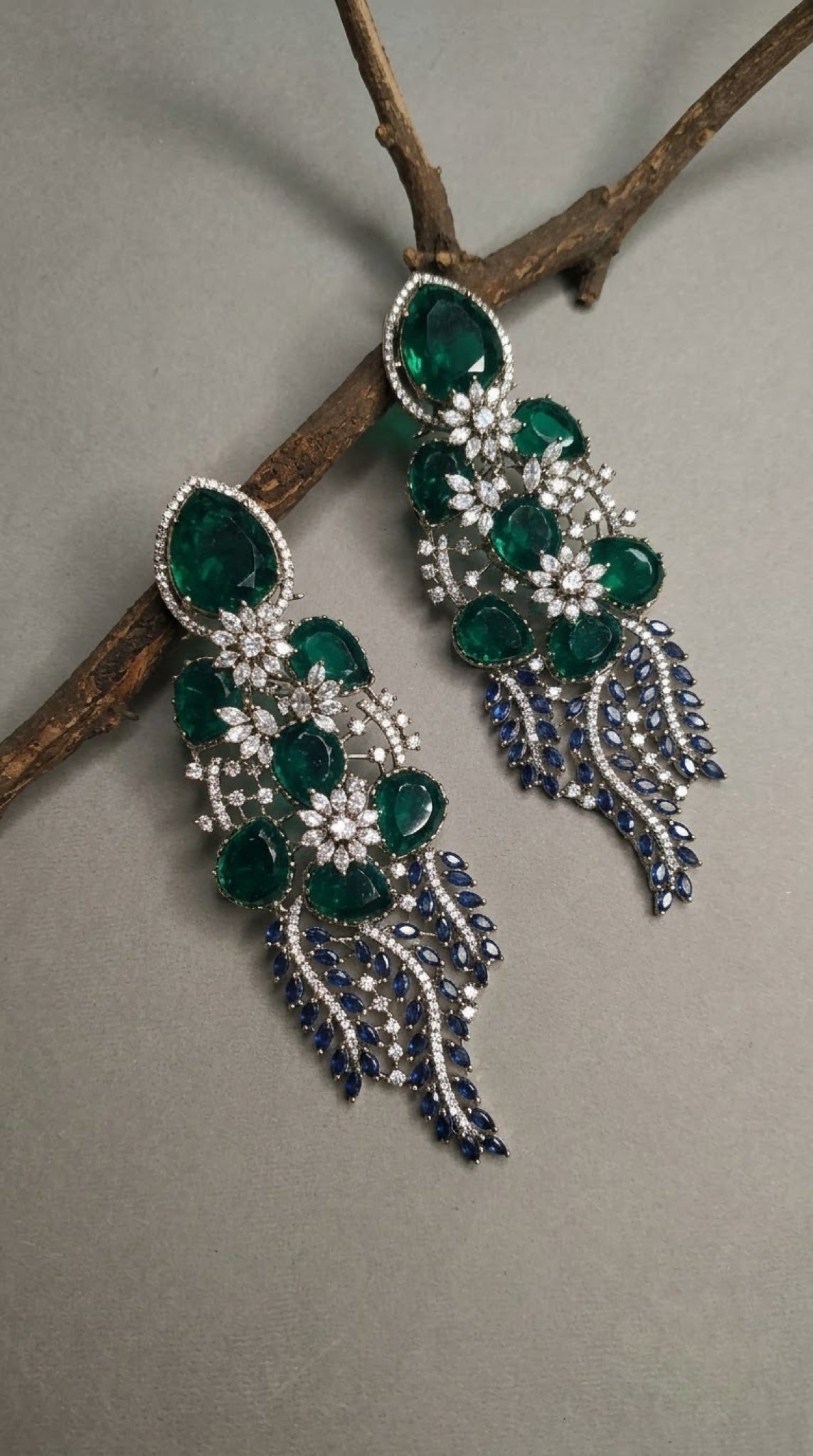 Long fringe earrings with emerald-green stones and blue marquise cascade