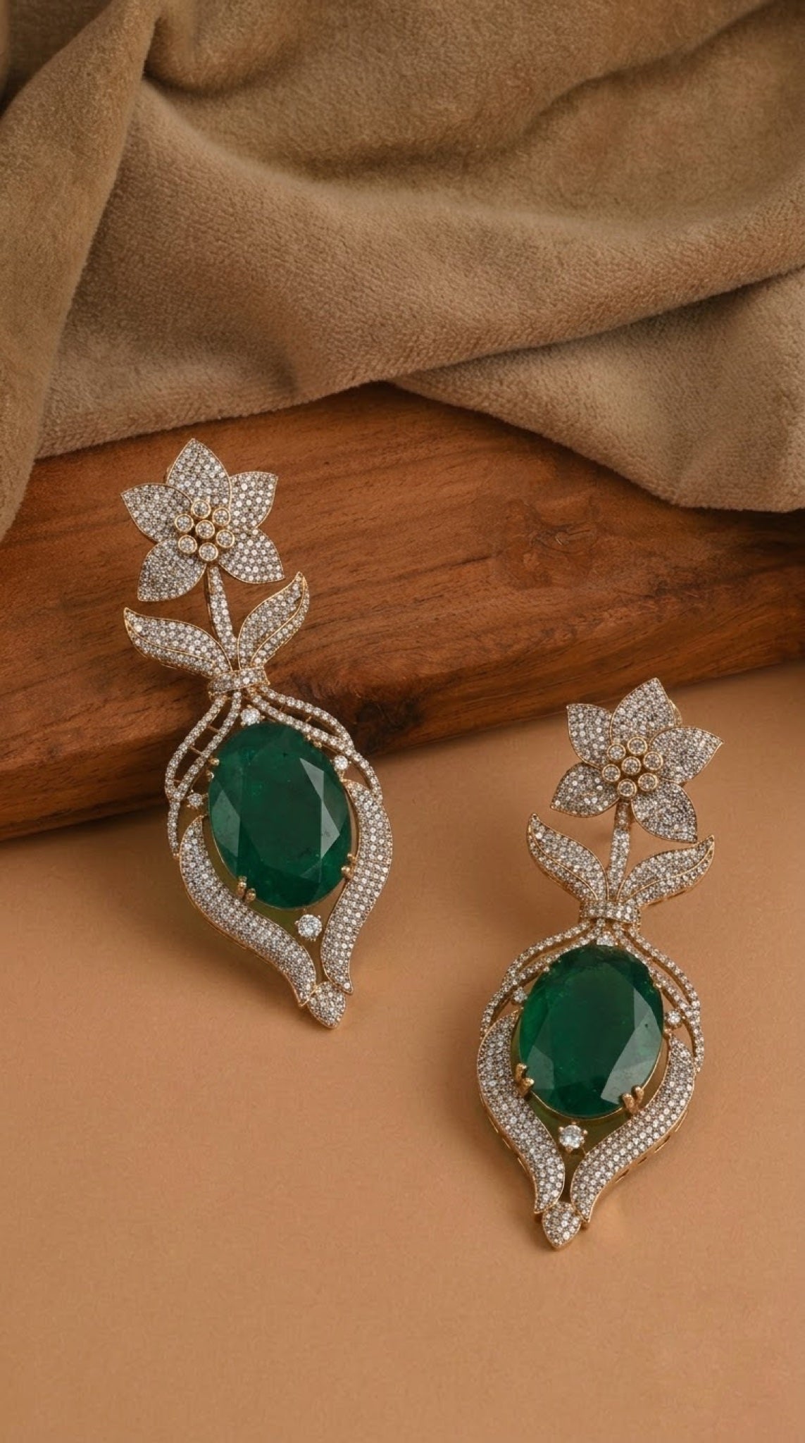 Gold-tone drop earrings with oval green stone and crystal star-flower top