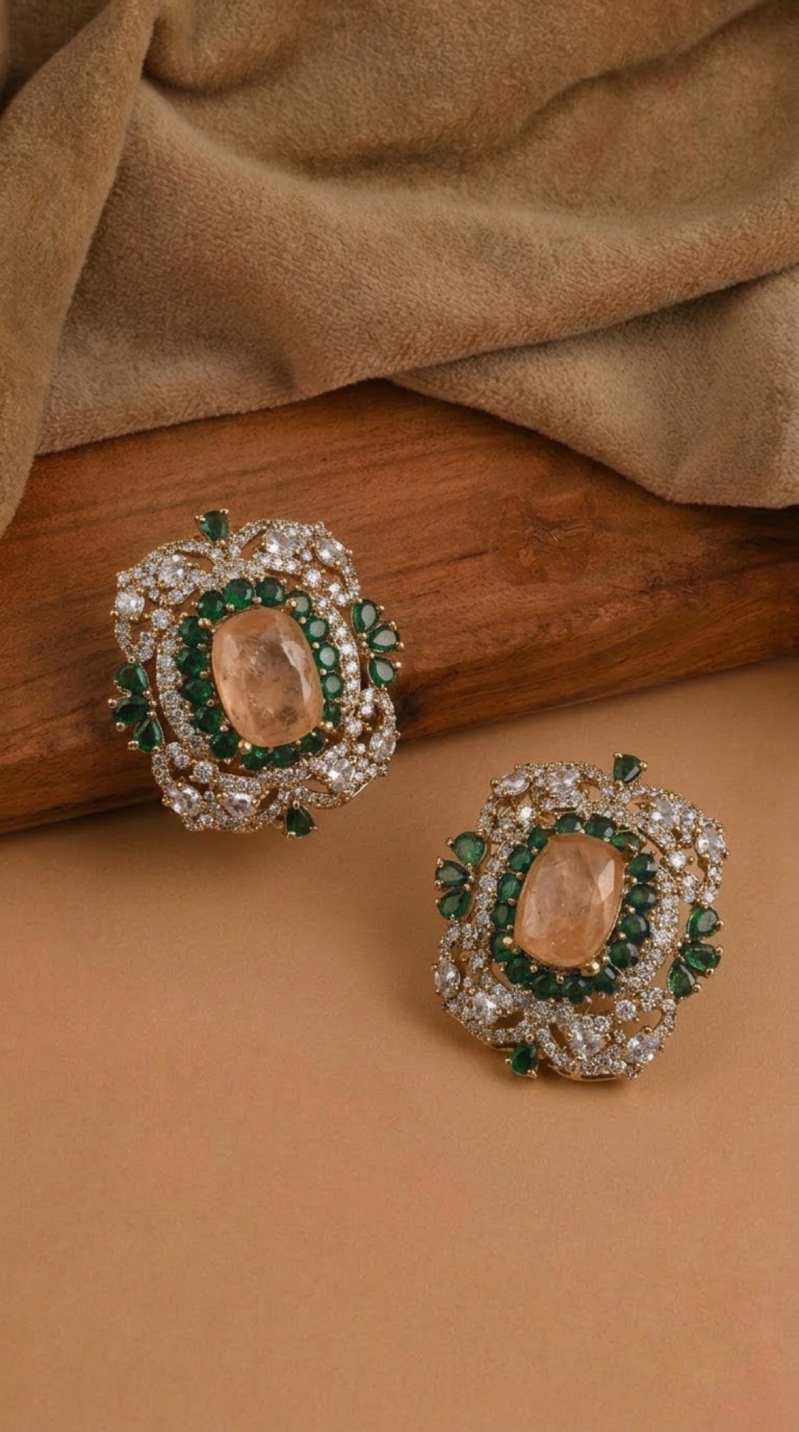 Statement stud earrings with peach cushion stone and green accents