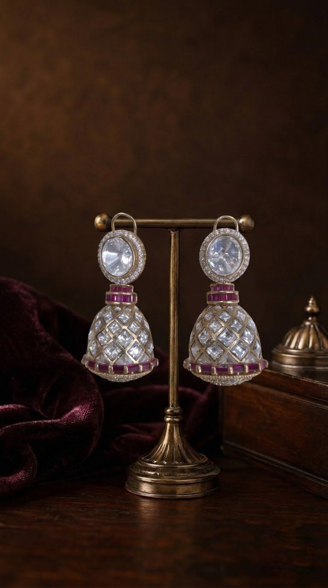 Gold-tone kundan jhumka earrings with ruby-red baguette bands