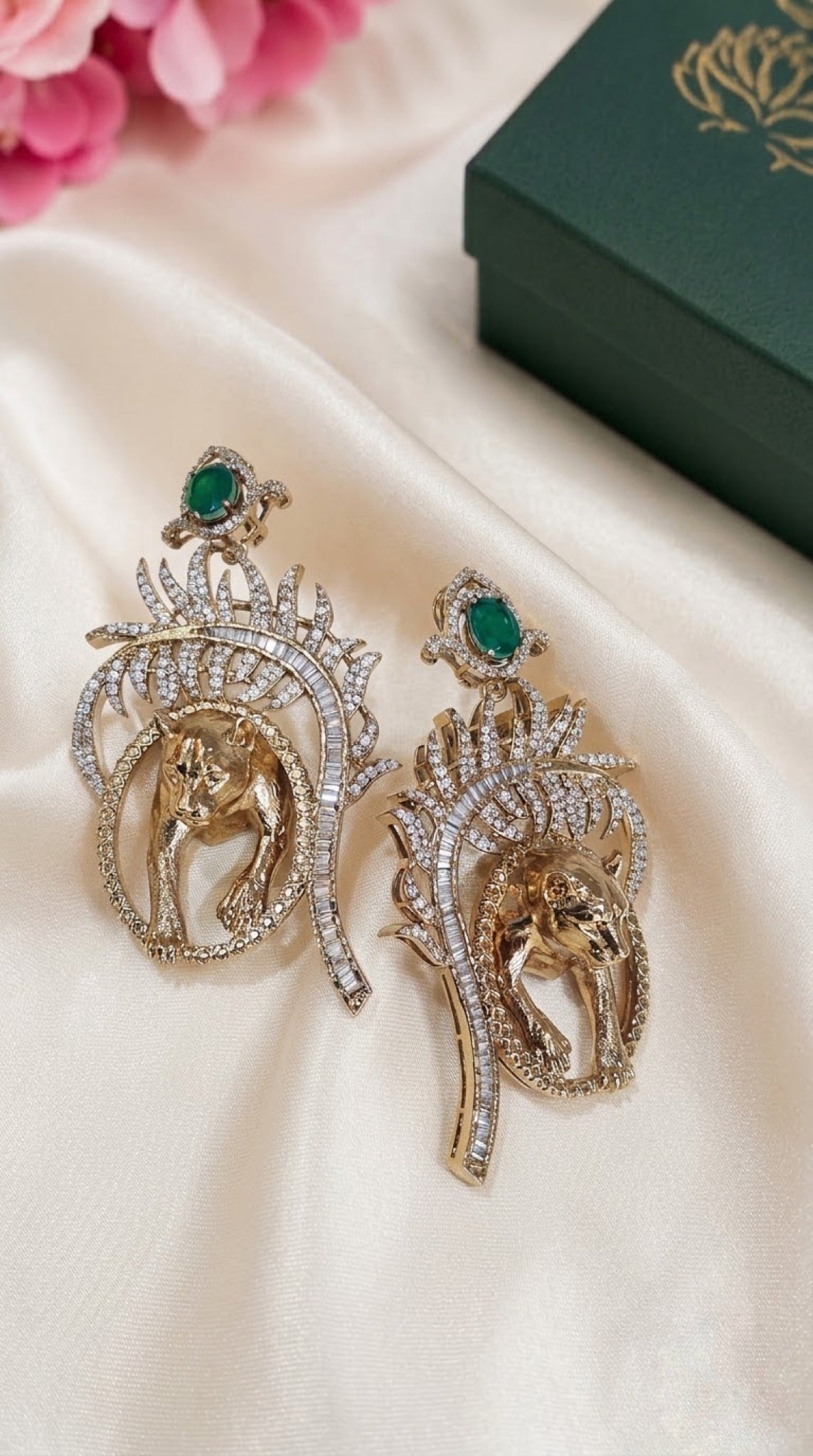 Dual-tone tiger earrings with baguette crystal plume and green stone