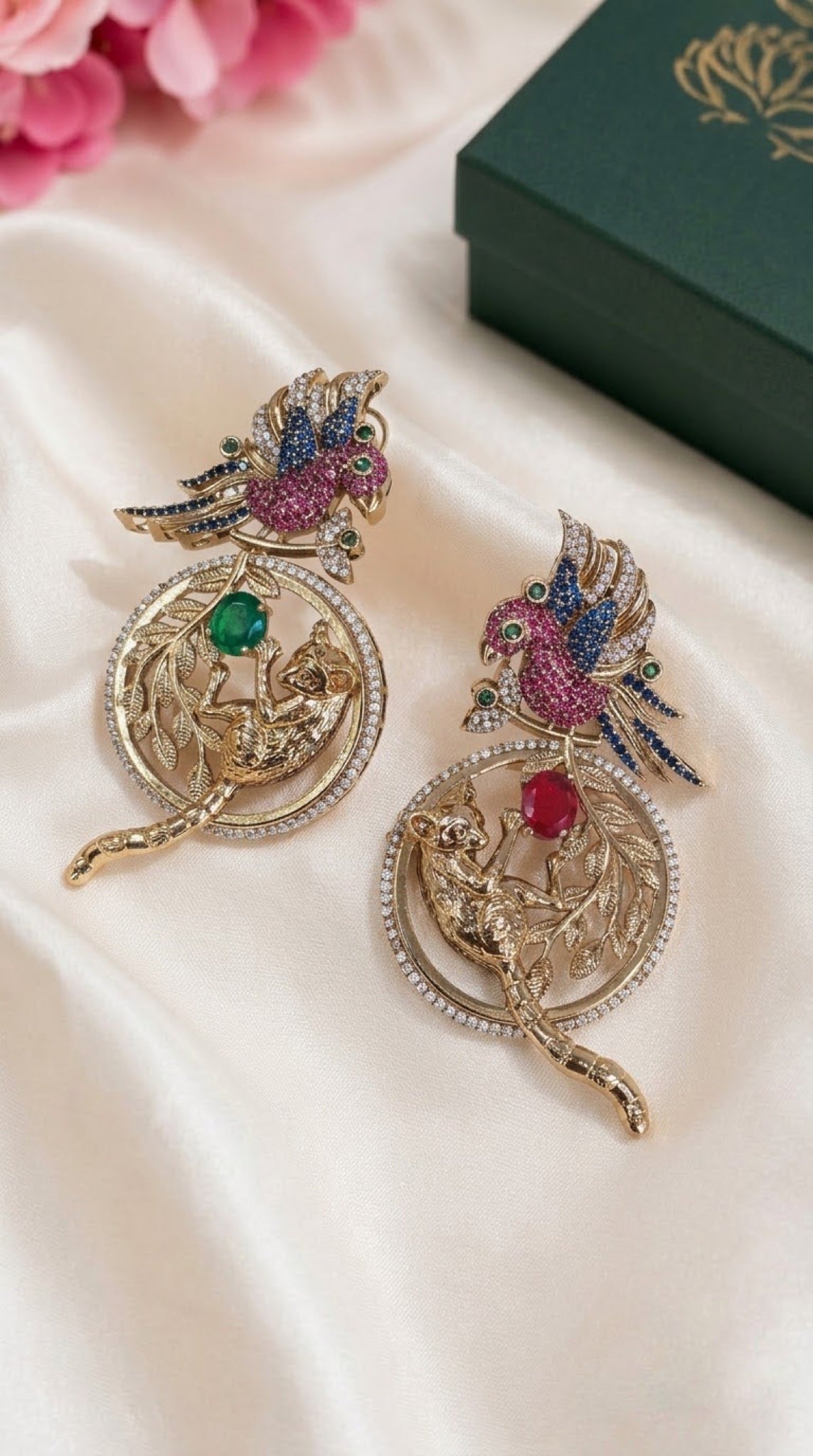 Gold-tone parrot and leopard medallion earrings with pink, blue, red and green crystals