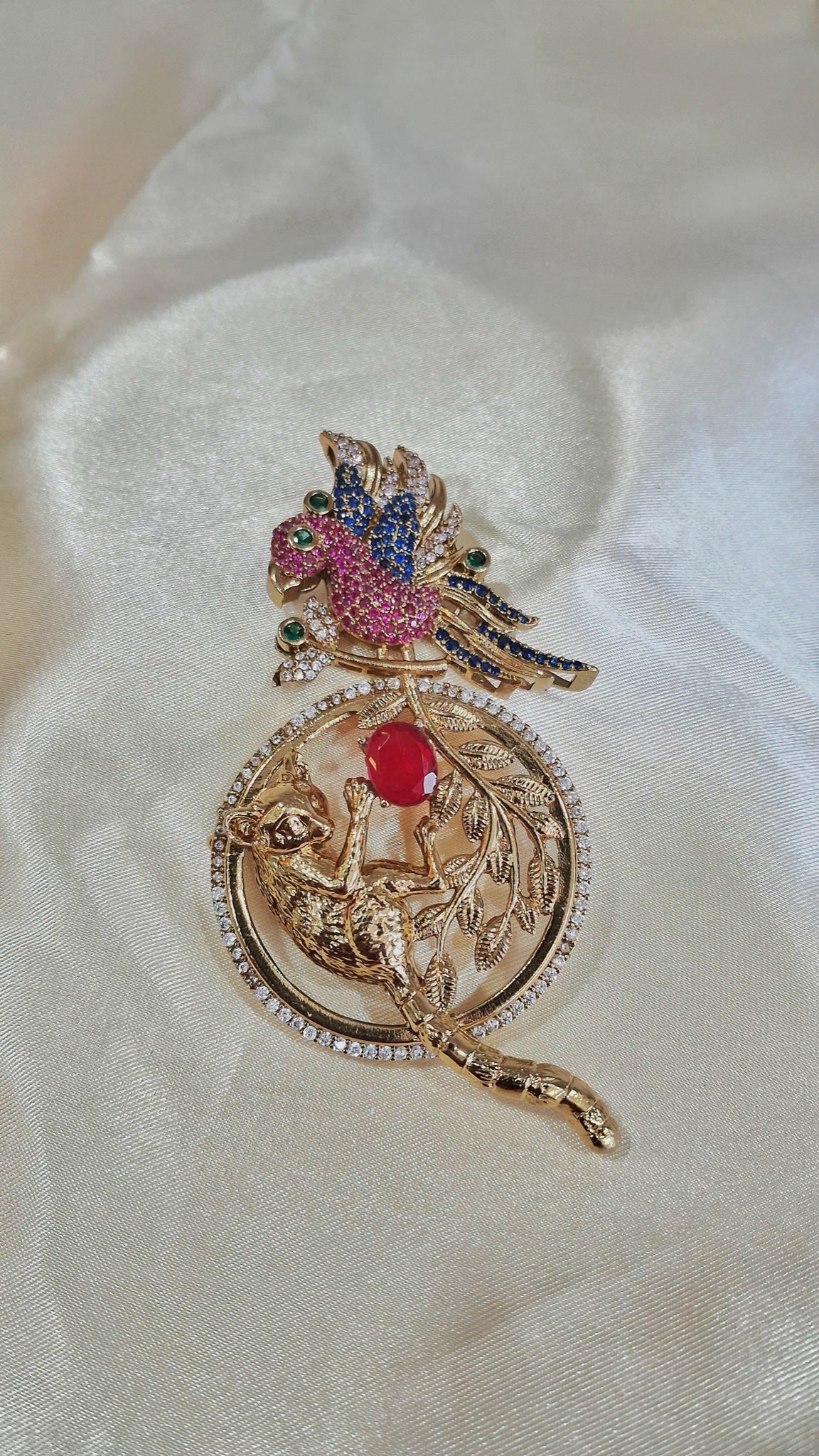 Gold-tone parrot and leopard medallion earrings with pink, blue, red and green crystals - view 2