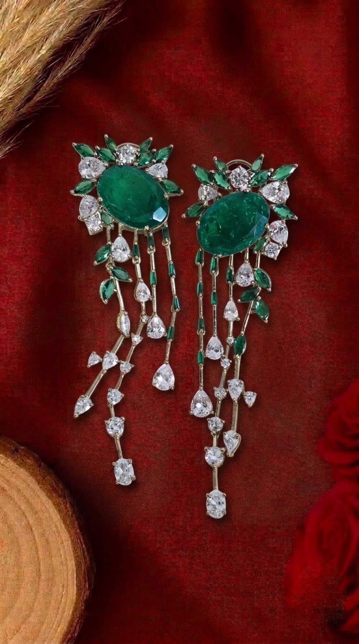 Gold-tone cascade earrings with emerald-green oval stone and CZ drops