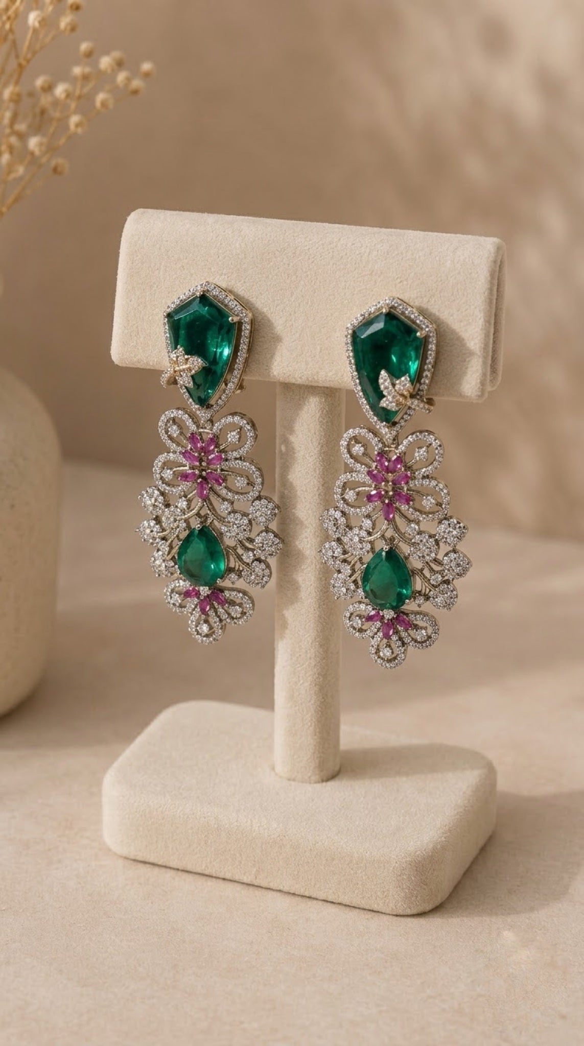 Gold-tone filigree earrings with emerald-green stones and pink crystals