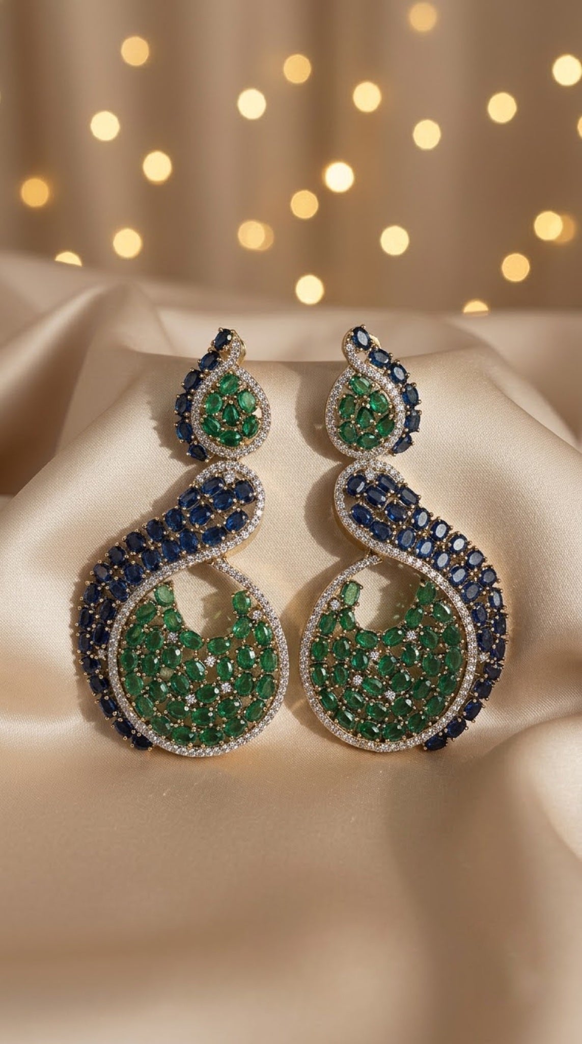 Swirl crescent earrings with emerald-green and sapphire-blue stones