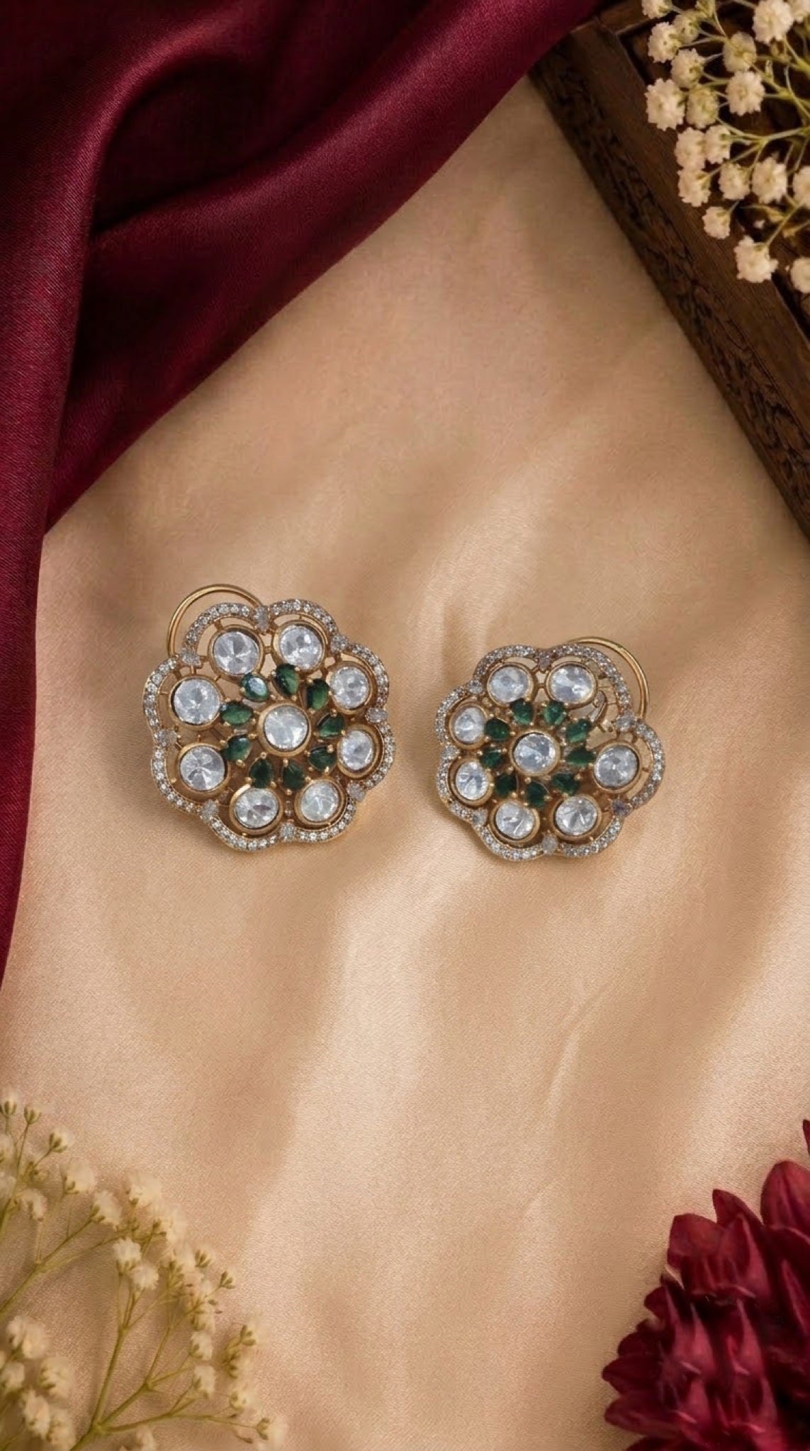 Gold-tone floral stud earrings with polki-look stones and green accents