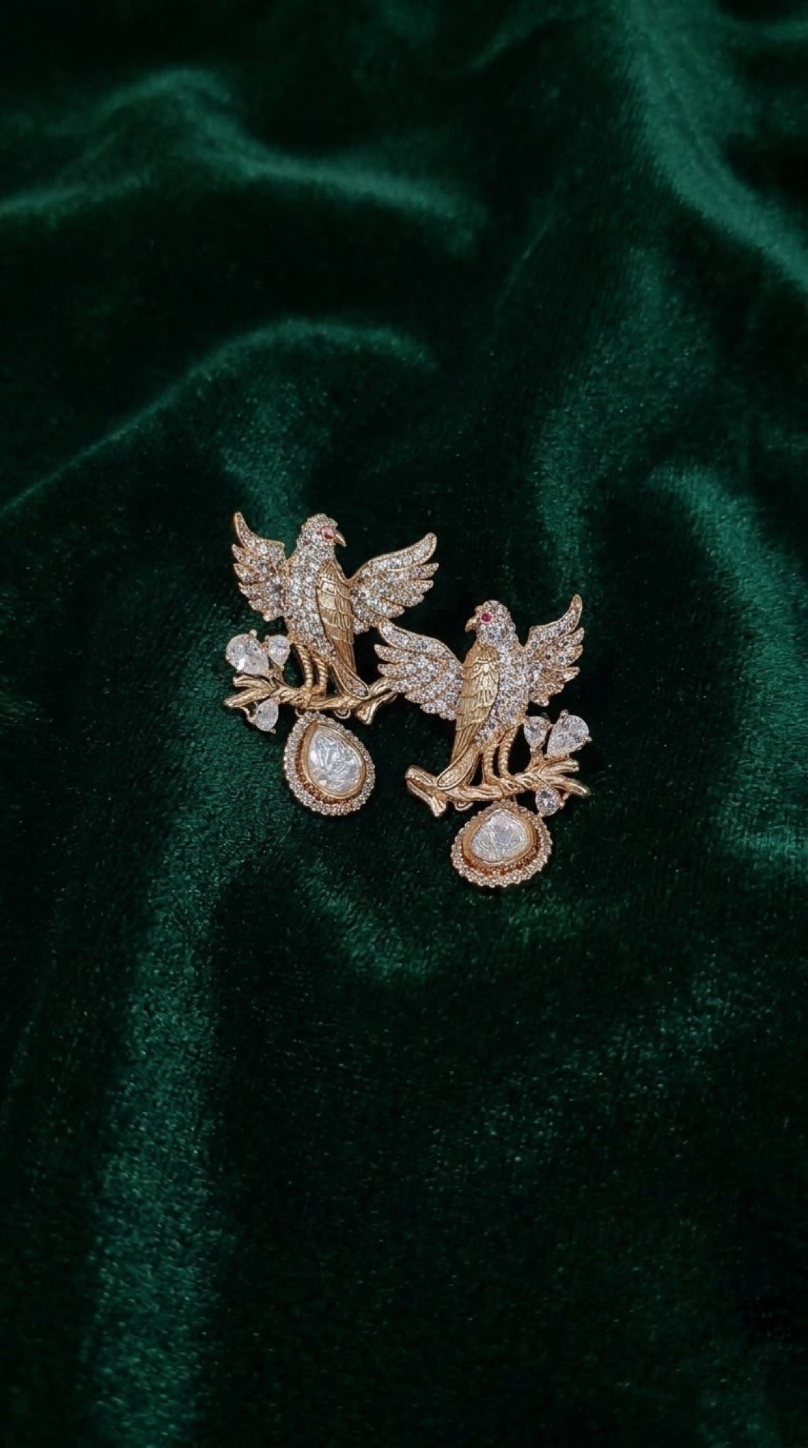 Gold-tone eagle earrings with crystal wings and polki-look drop