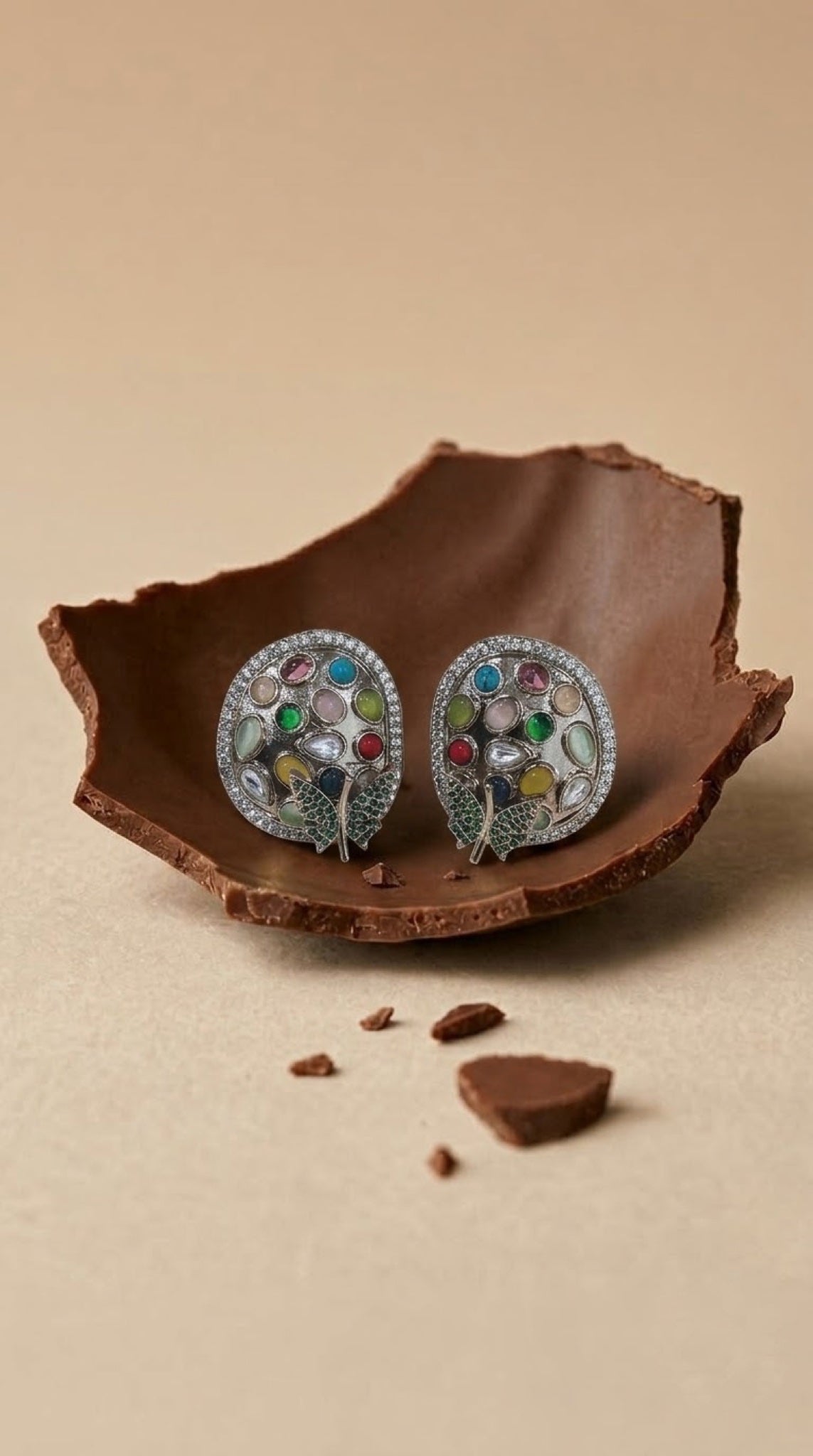 Silver-tone oval stud earrings with multicolour stones and green pavé leaf