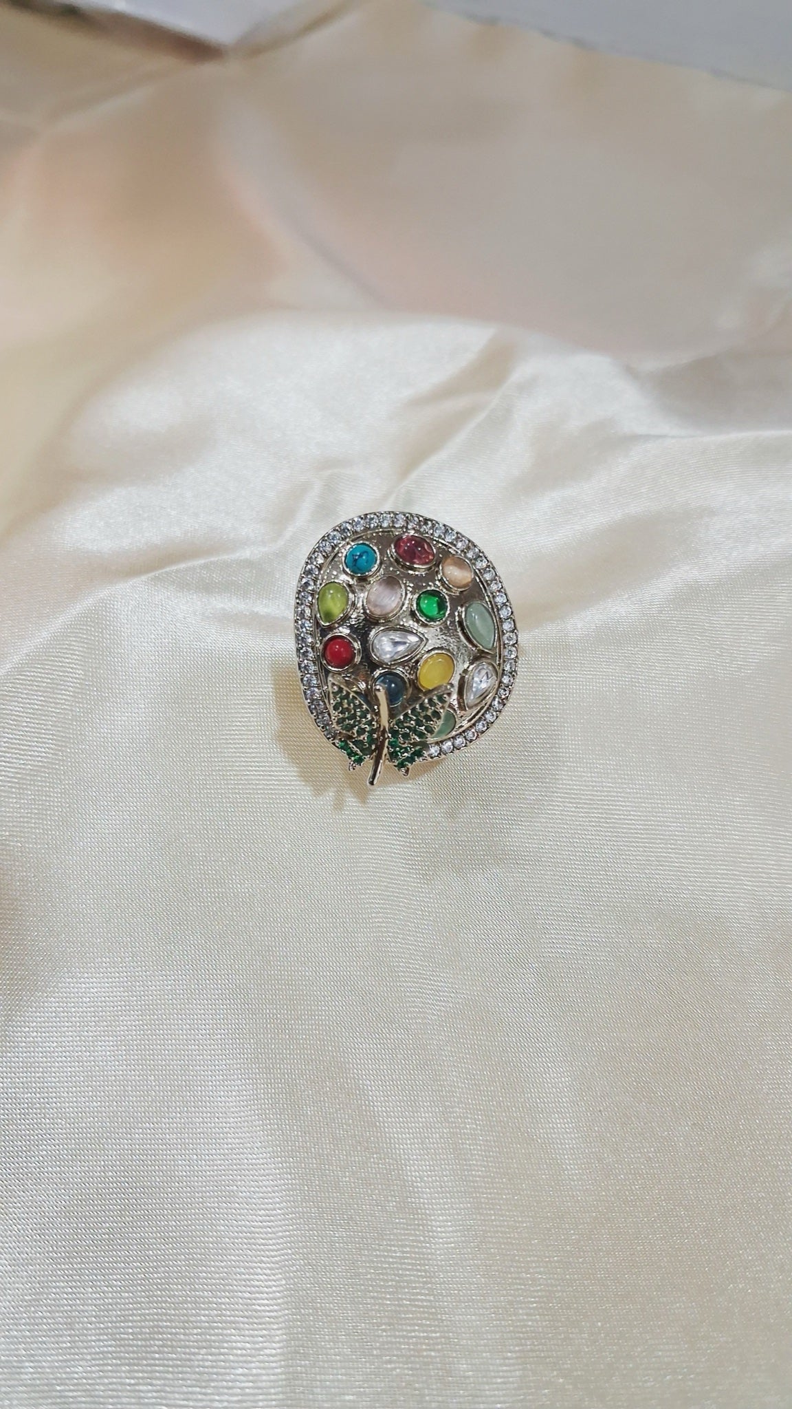 Silver-tone oval stud earrings with multicolour stones and green pavé leaf - view 2