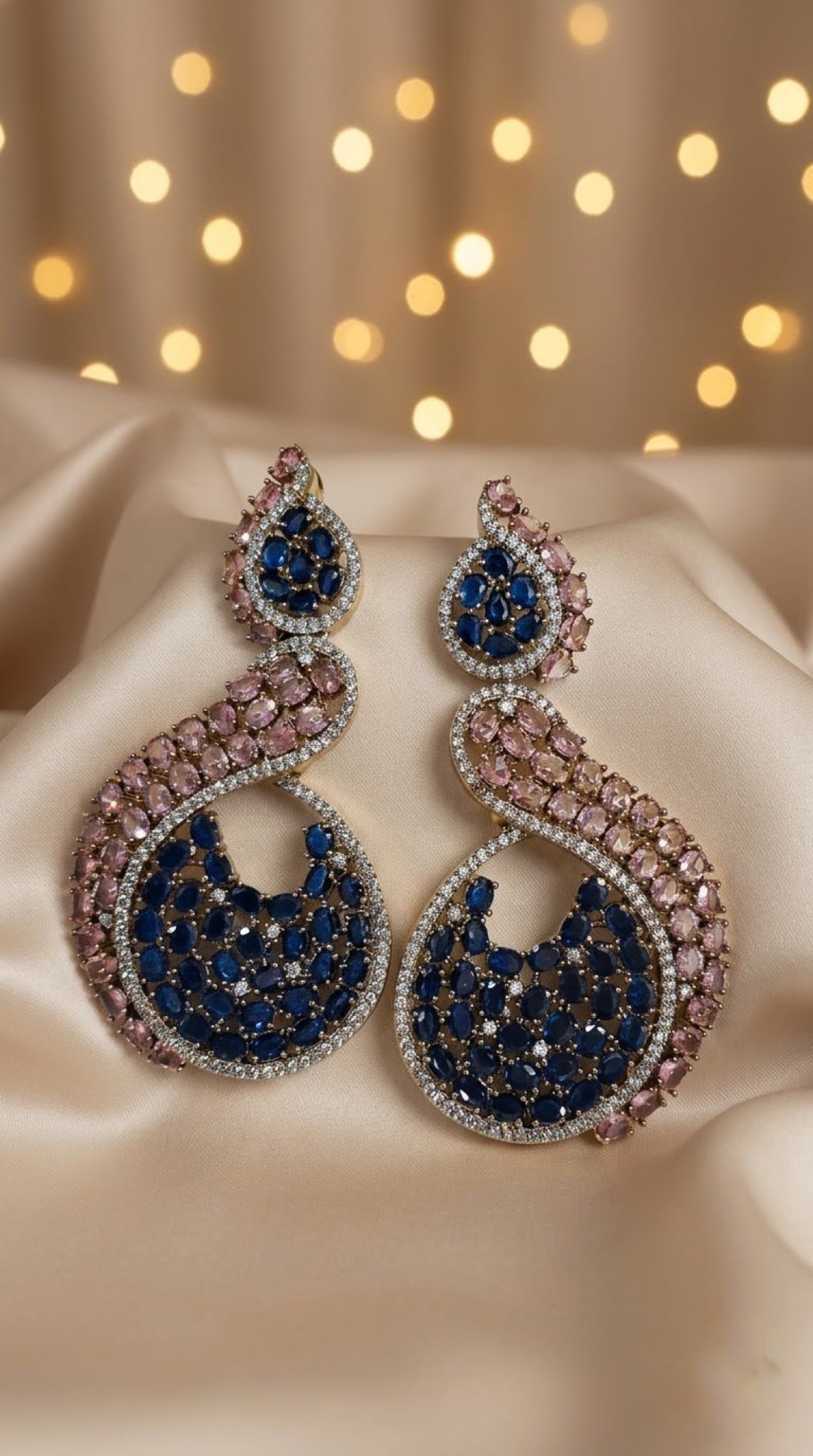 Swirl crescent earrings with peach and sapphire-blue stones