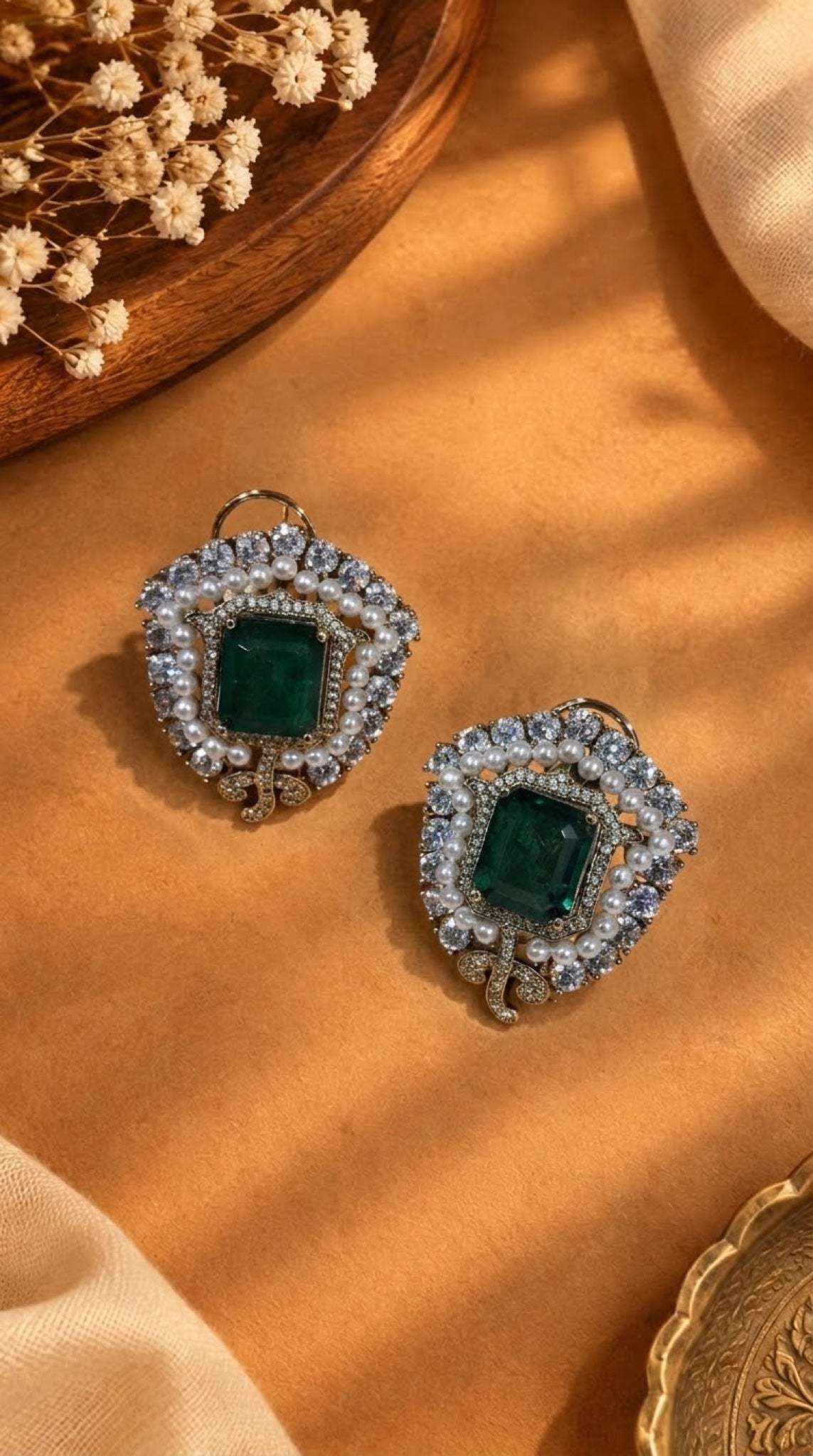 Shield-shaped stud earrings with green stone, faux pearls and crystals