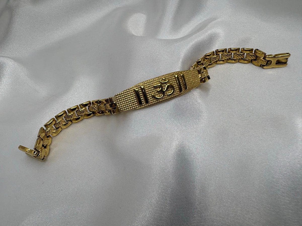 Gold-tone textured link bracelet with raised Om mantra bar