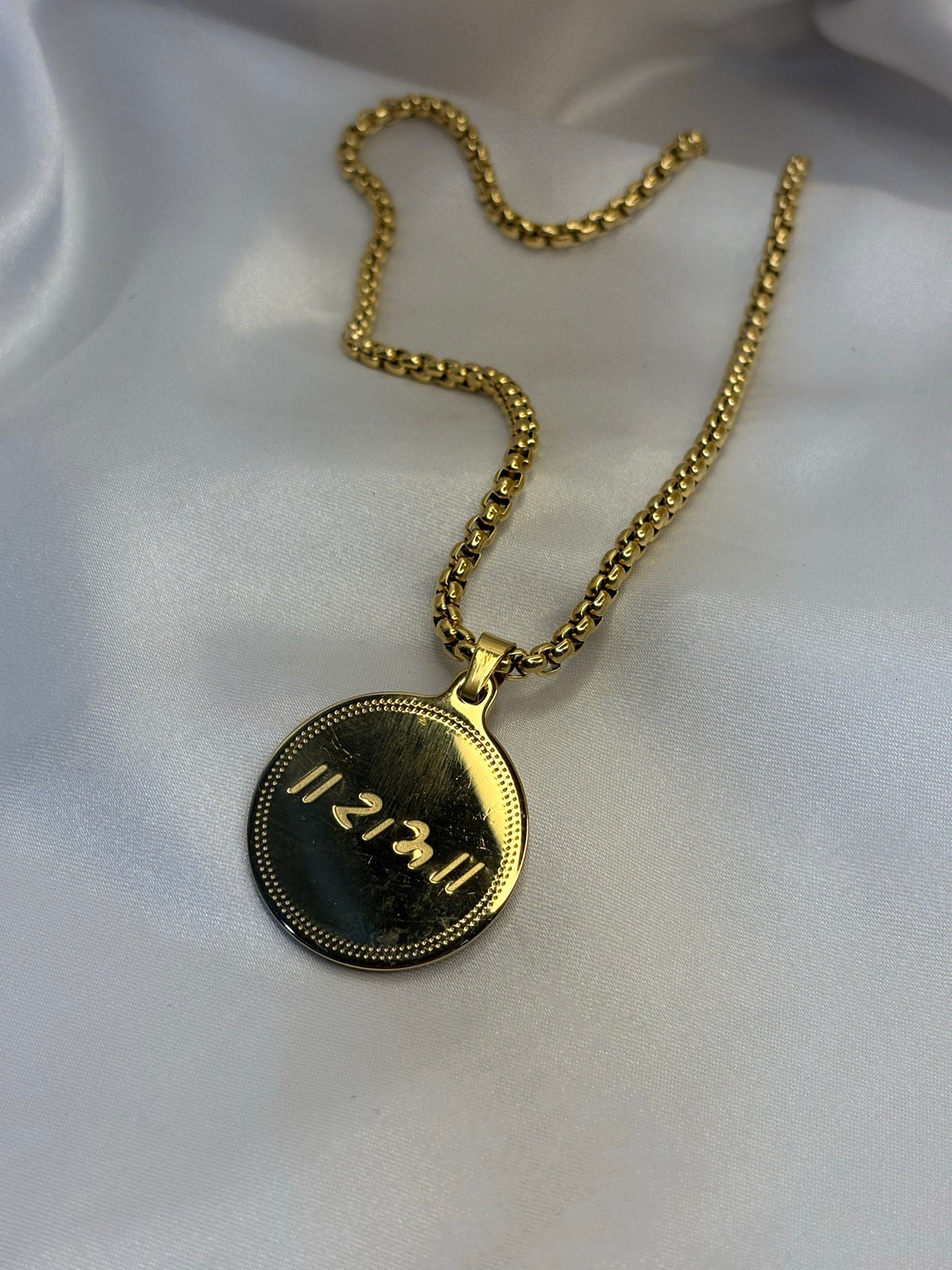 Gold-tone round coin pendant engraved with Ram naam on box chain