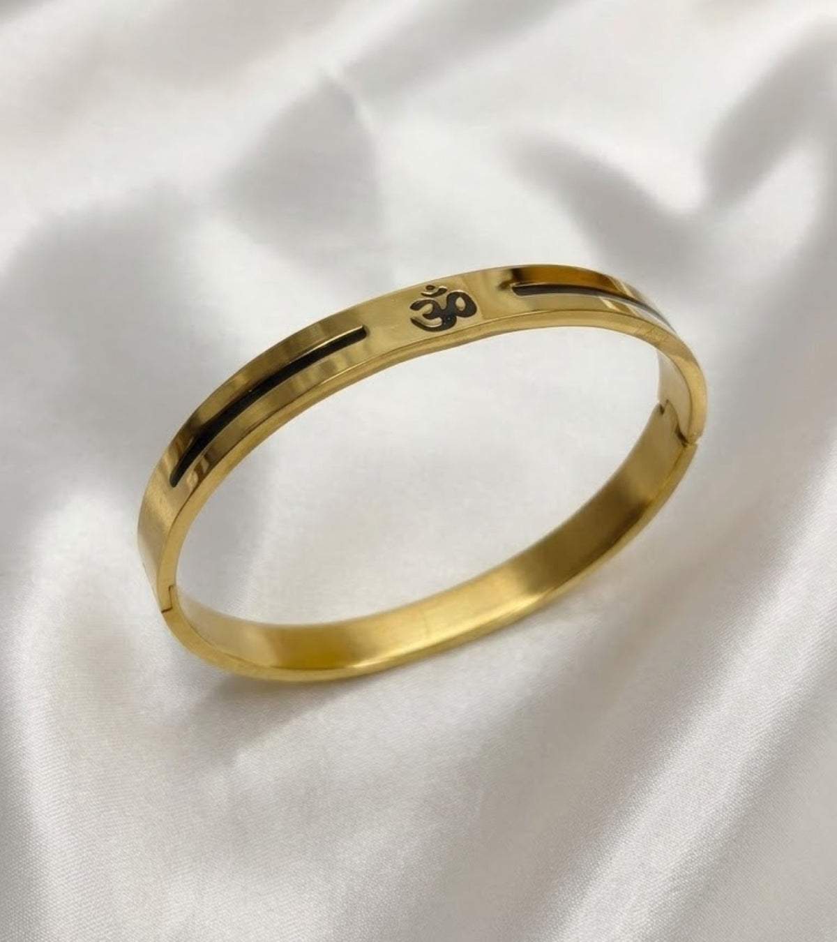 Polished Om kada bracelet with black Om symbol and black inlaid groove line