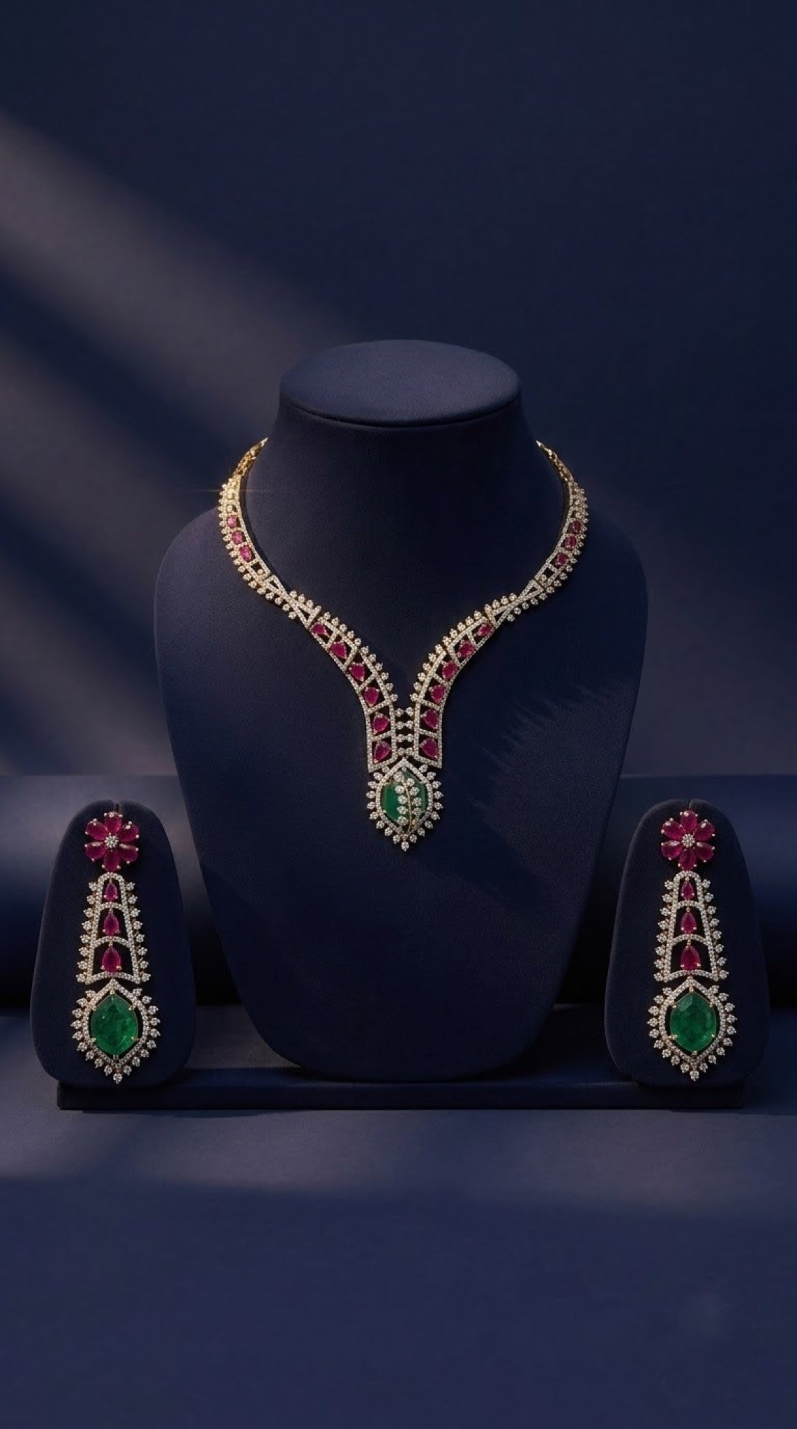 Gold-tone V-shaped necklace set with ruby-red and emerald-green crystals