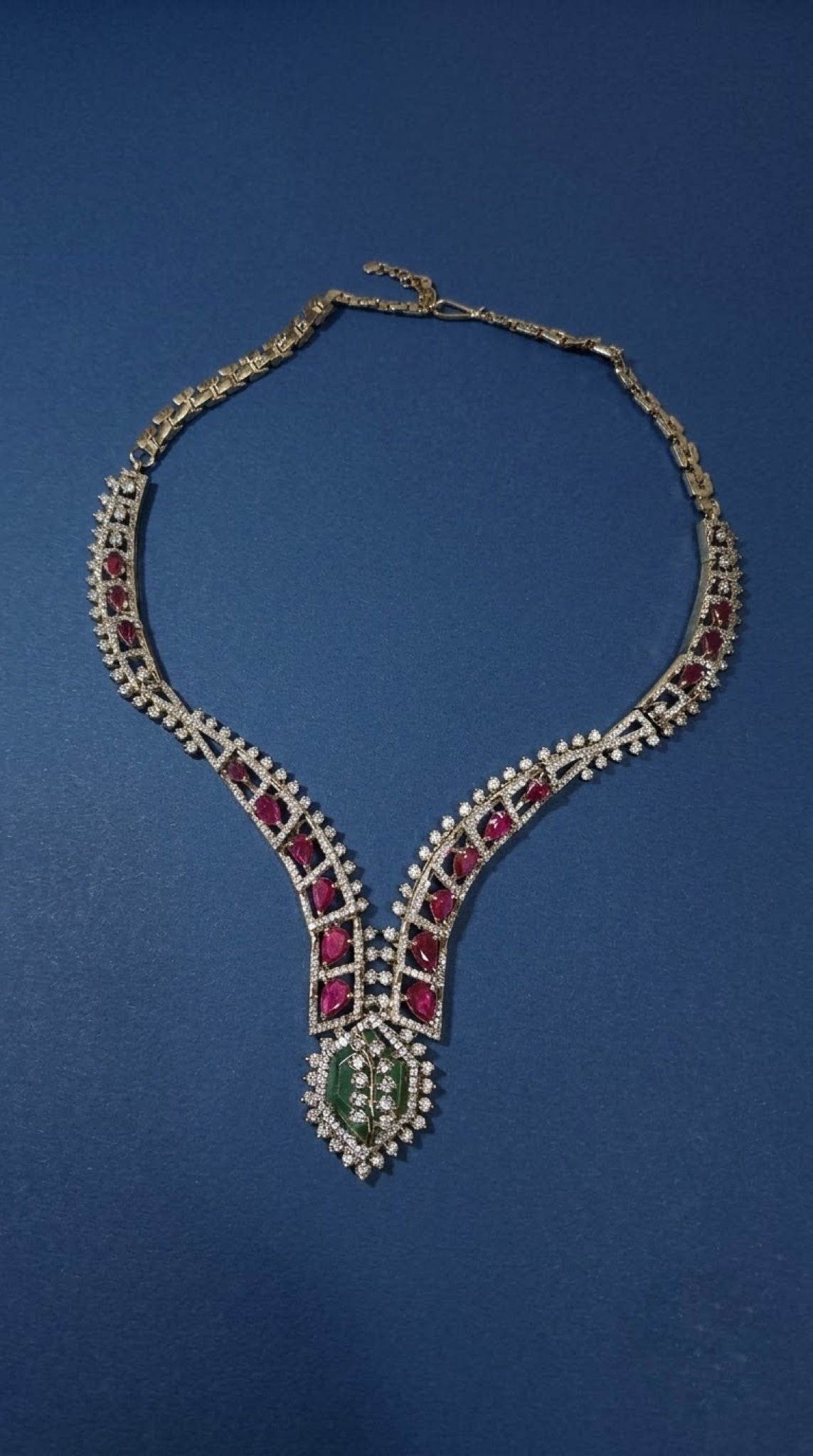 Gold-tone V-shaped necklace set with ruby-red and emerald-green crystals - view 3