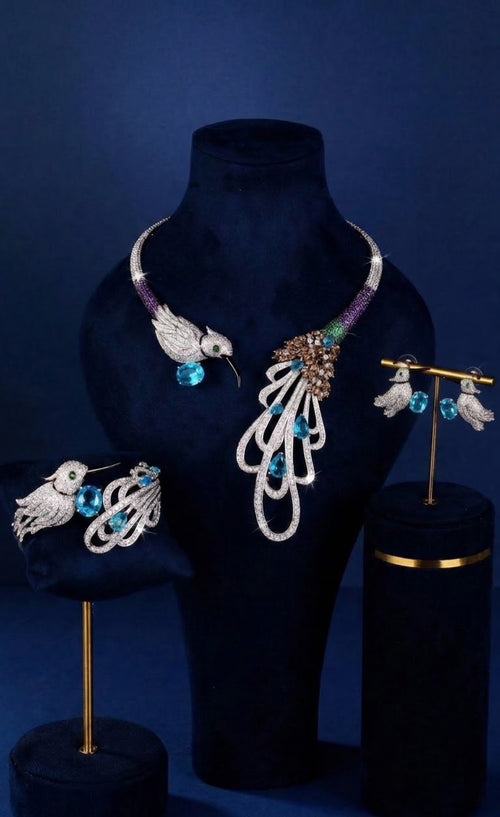 Silver-tone hummingbird collar necklace set with aqua-blue stones, earrings and bangle