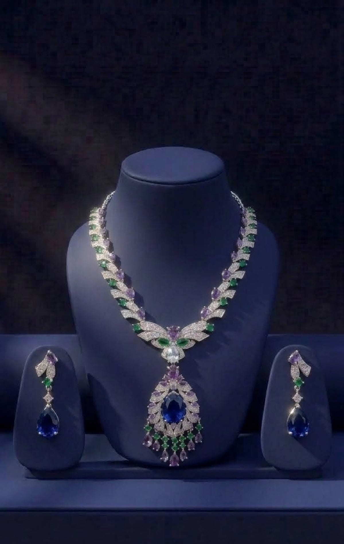 Silver-tone necklace set with green and lilac crystals and sapphire-blue pear drop