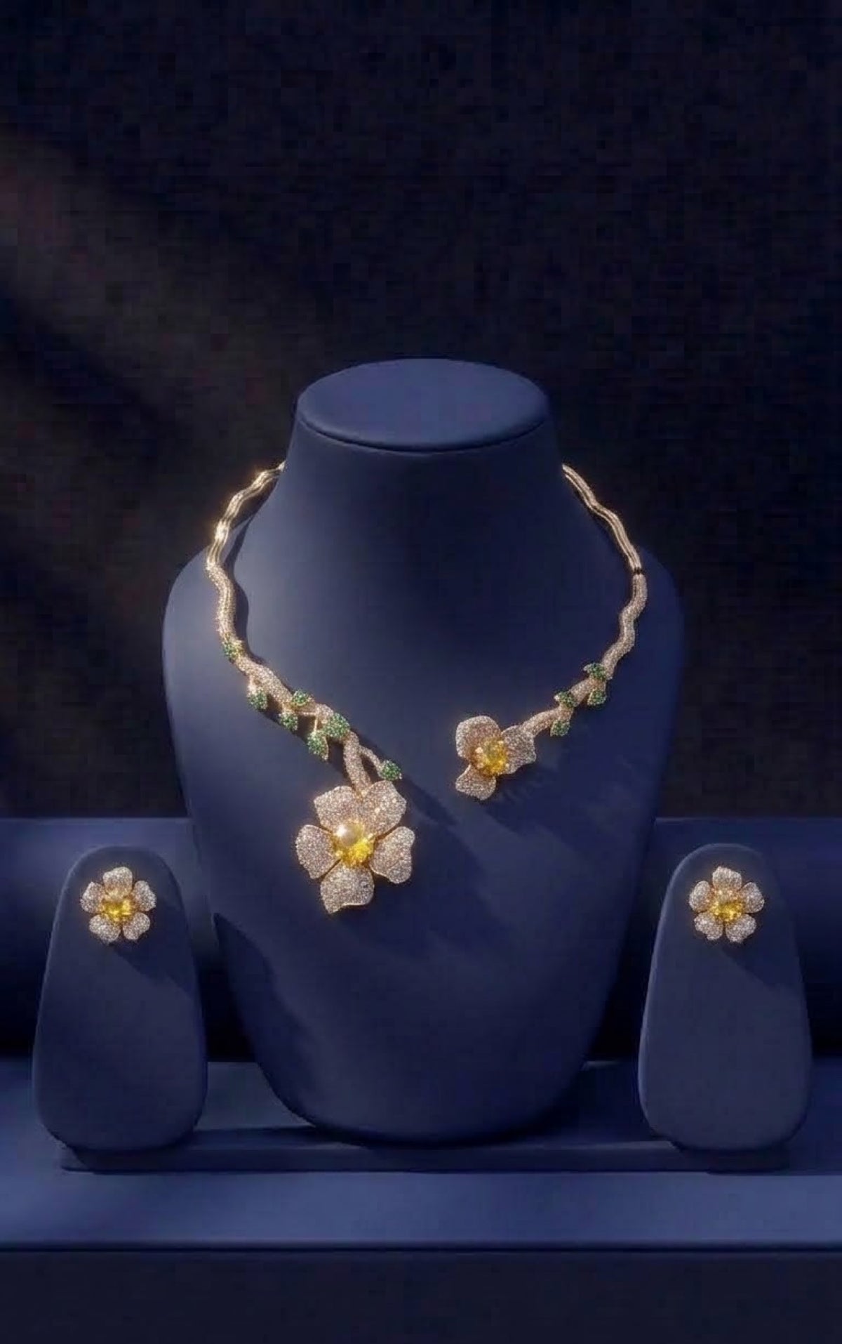 Gold-tone open collar necklace set with crystal flowers and green leaf stones