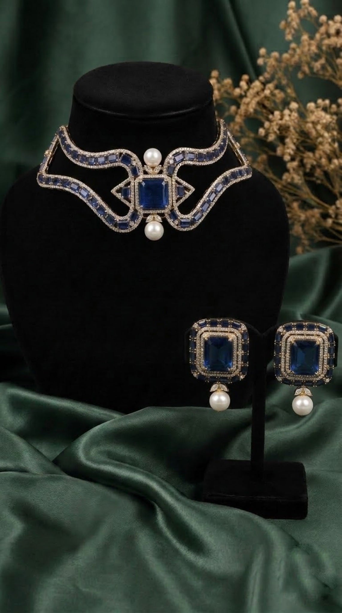 Gold-tone choker necklace set with sapphire-blue stones and faux pearl drops
