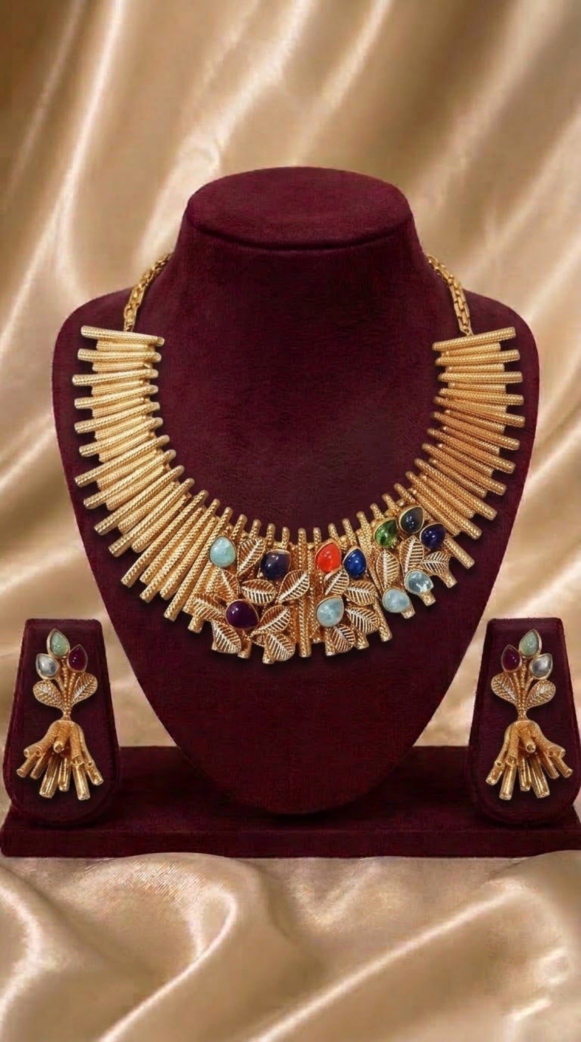 Gold-tone sunburst bib necklace set with multicolour stones and tassel earrings