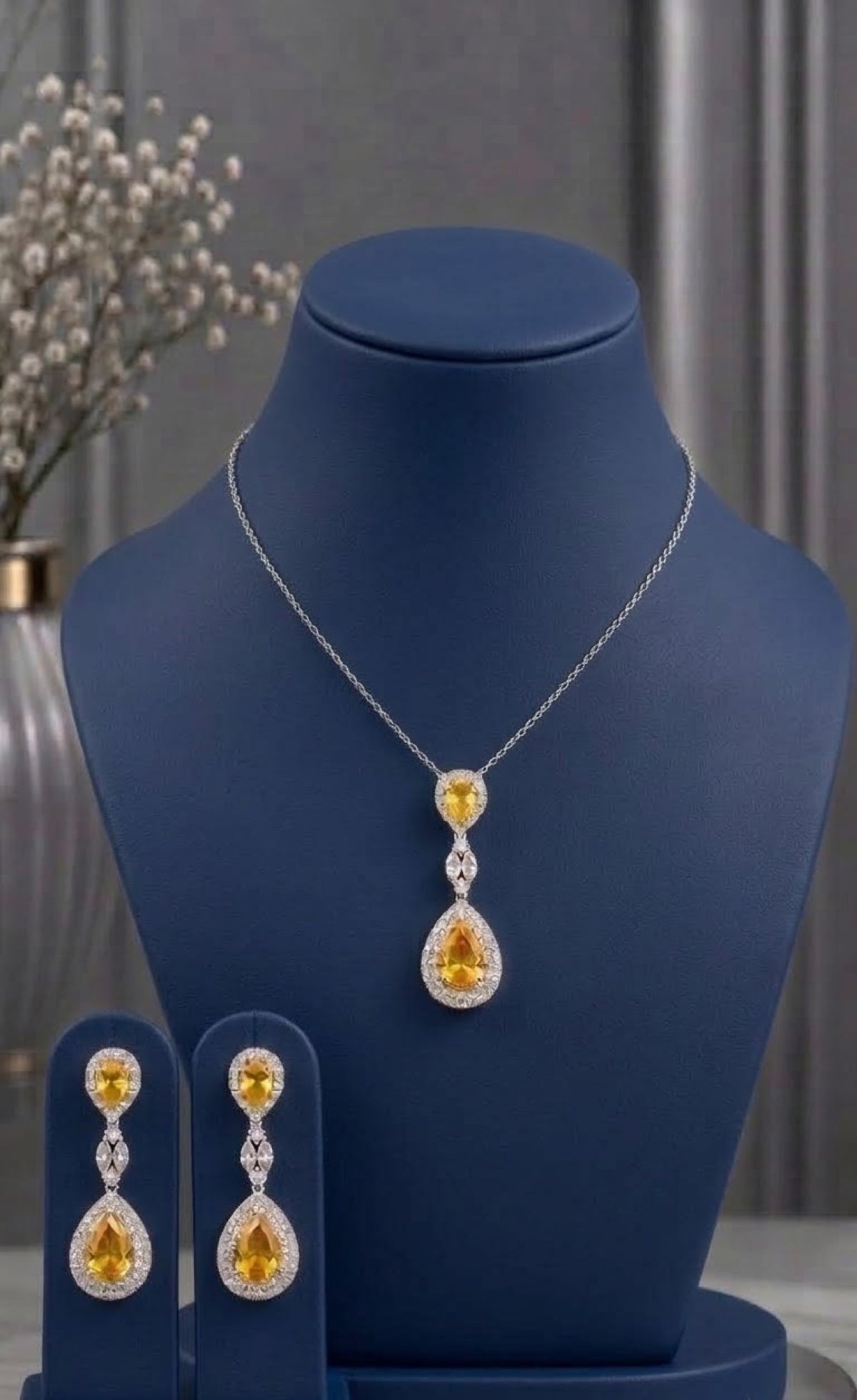 Silver-tone pendant set with yellow teardrop stones and crystal halos