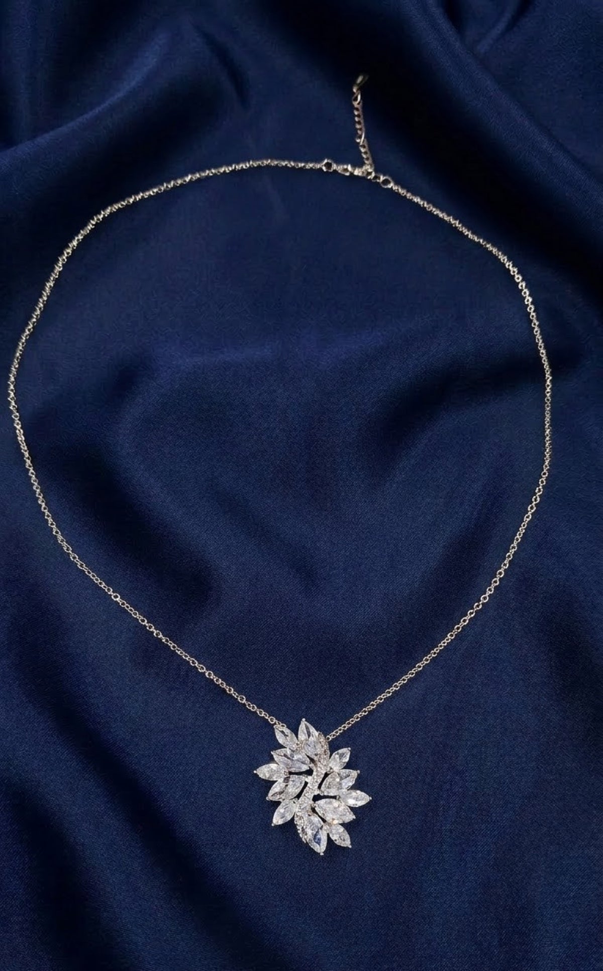Silver-tone leaf cluster pendant set with clear marquise crystals