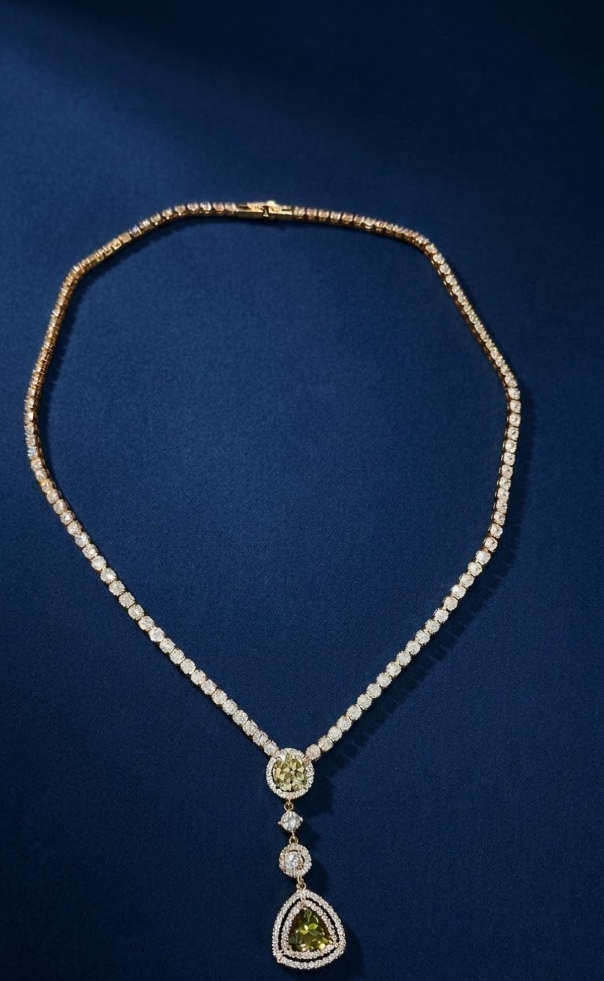 Gold-tone pendant set with olive-green trillion drops and crystals