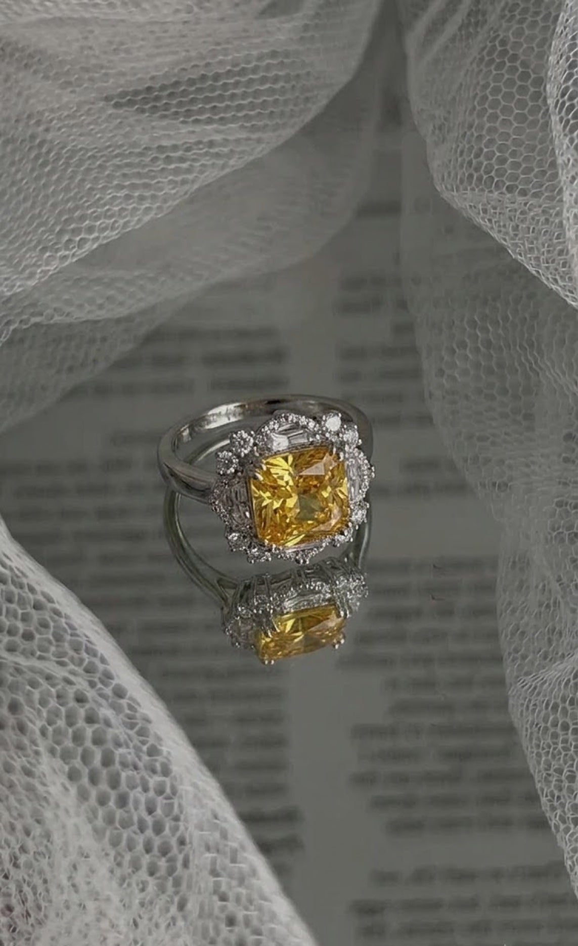 Silver-tone halo ring with an octagon-cut yellow crystal framed by clear diamond-look crystals