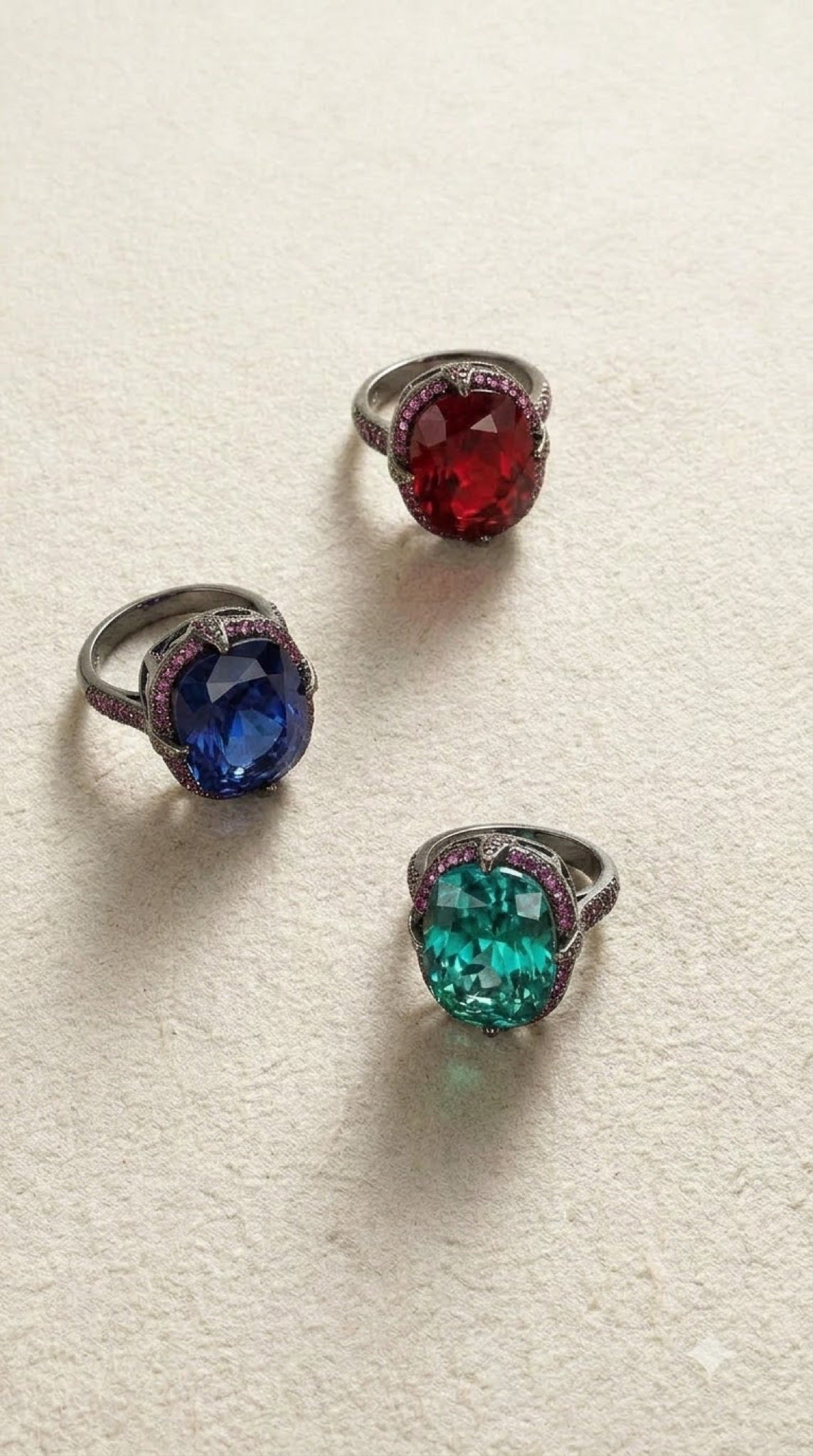 Gunmetal black-tone gothic ring with a claw-set oval crystal and berry-toned pavé
