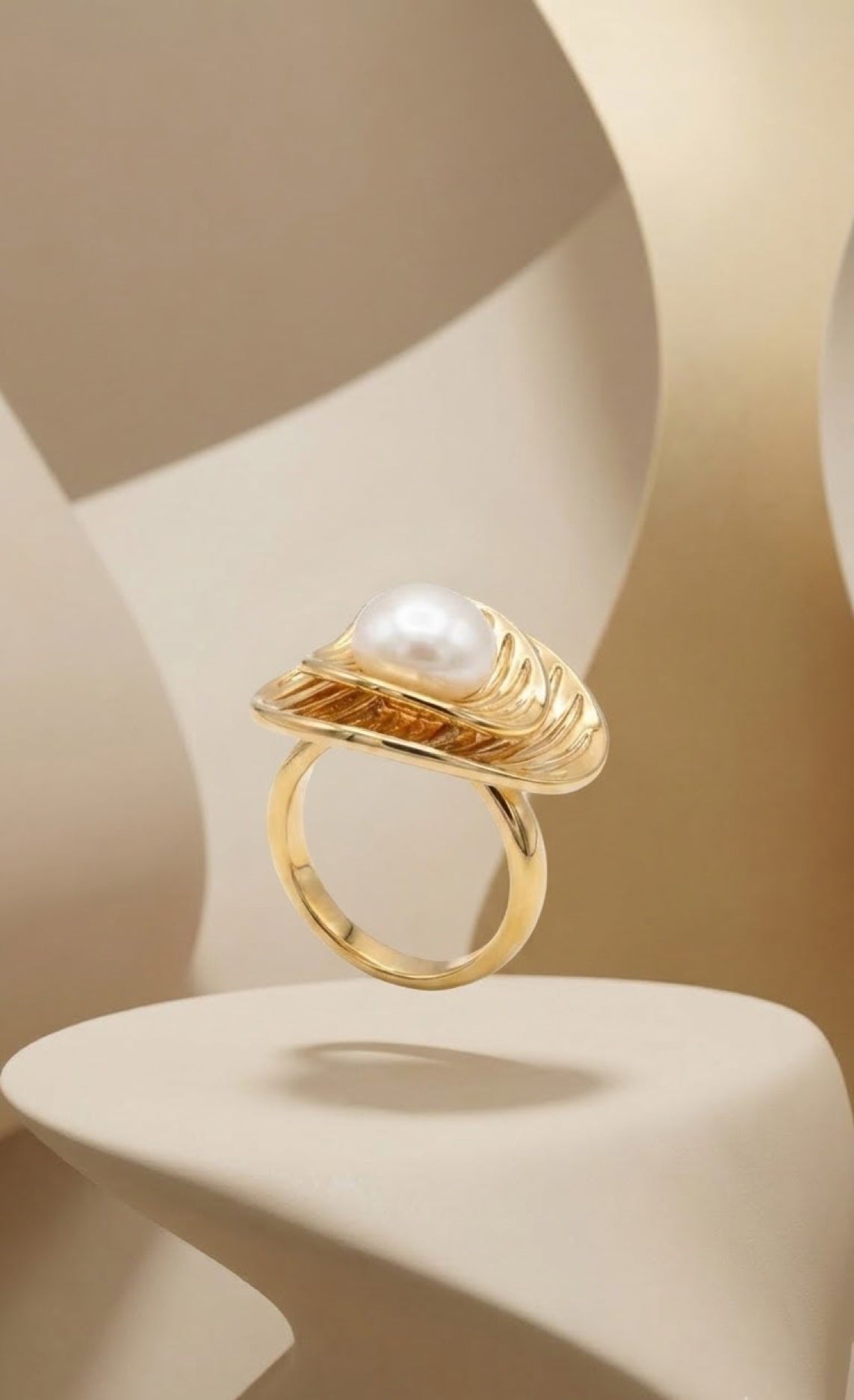 Gold-tone seashell ring holding a single faux pearl