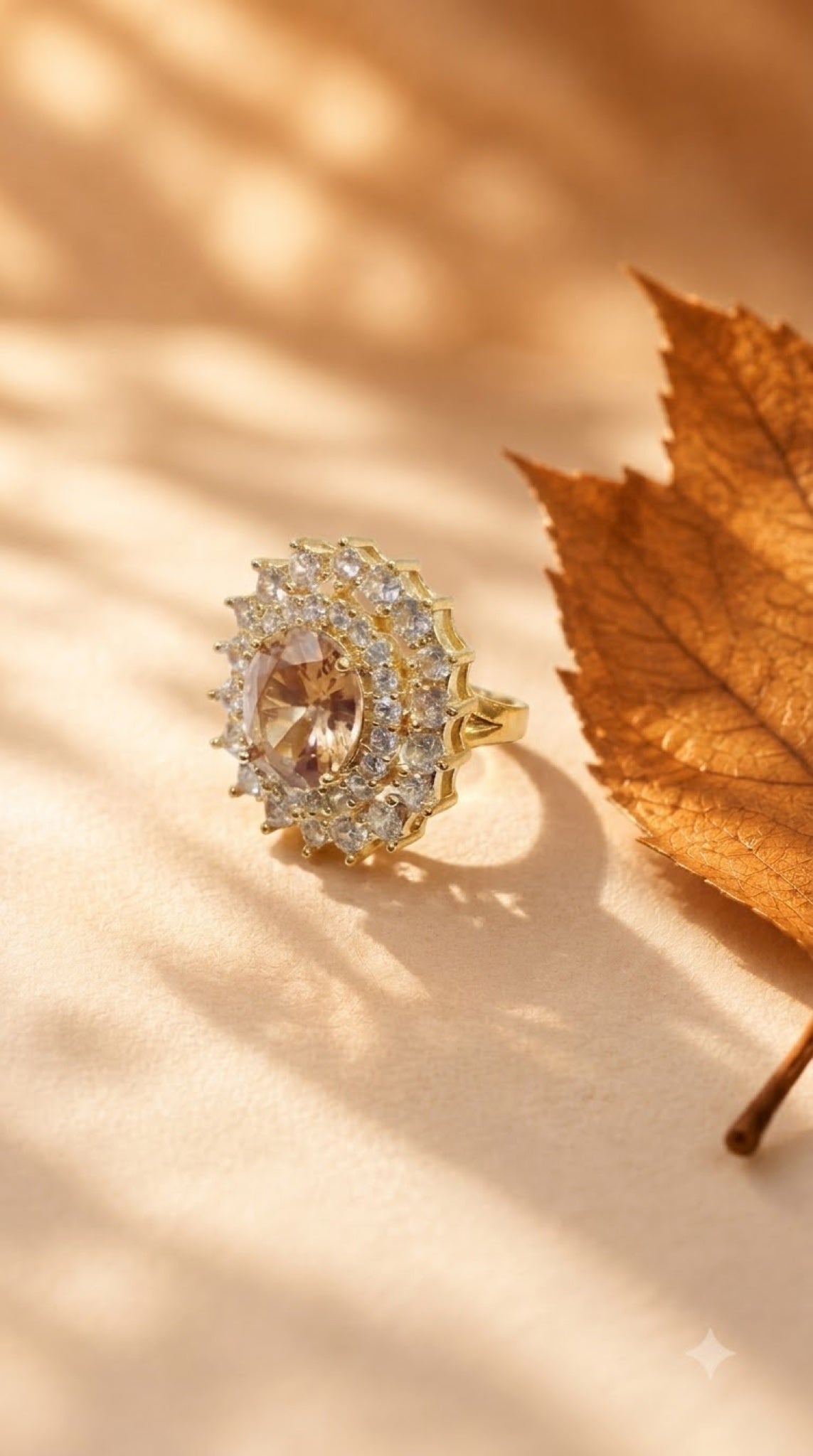 Gold-tone double halo cocktail ring with champagne centre stone and clear crystals