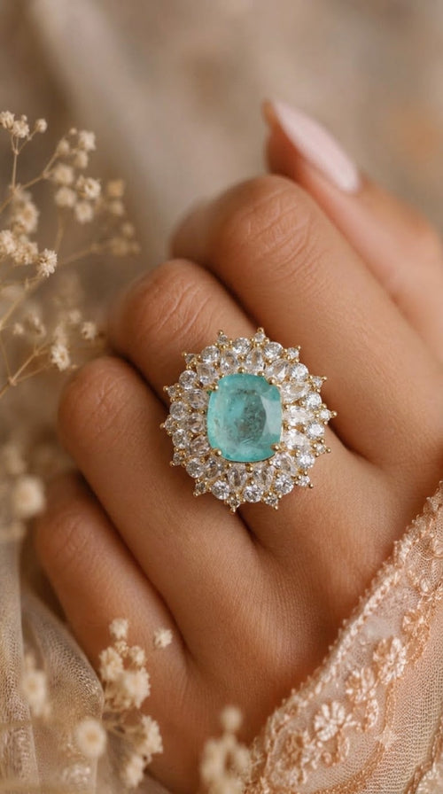 Gold-tone starburst cocktail ring with aqua blue centre stone and marquise crystals