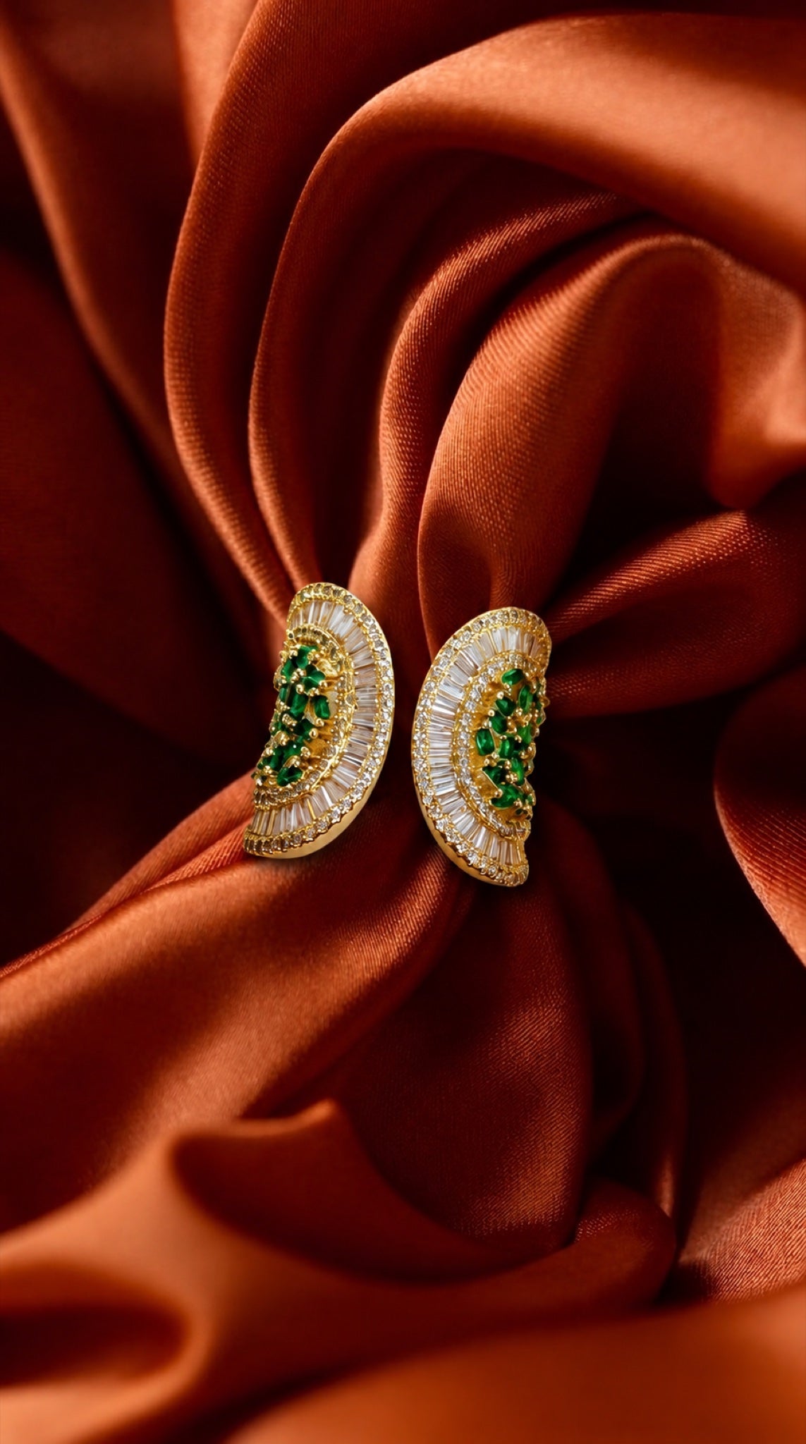 Gold-tone double paisley wrap ring with green crystals and baguette crystal borders
