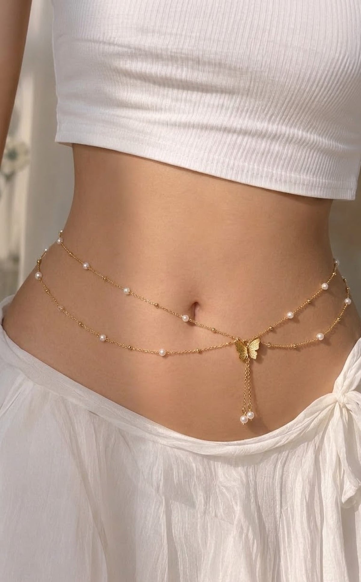 Double gold-tone waist chain with faux pearls and butterfly tassel drop
